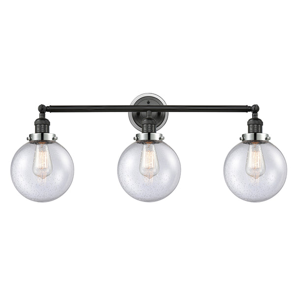 Beacon Bath Vanity Light shown in the Matte Black finish with a Seedy shade