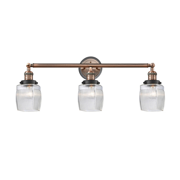 Colton Bath Vanity Light shown in the Antique Copper finish with a Clear Halophane shade