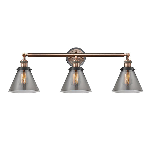 Cone Bath Vanity Light shown in the Antique Copper finish with a Plated Smoke shade