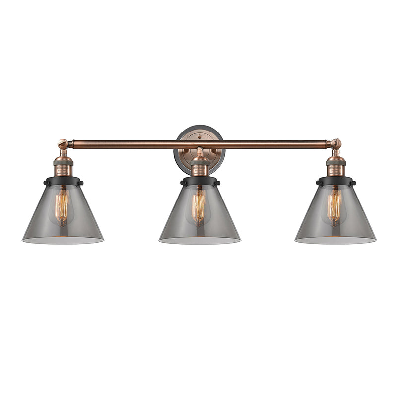 Cone Bath Vanity Light shown in the Antique Copper finish with a Plated Smoke shade