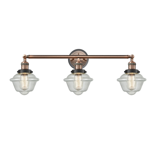 Oxford Bath Vanity Light shown in the Antique Copper finish with a Seedy shade