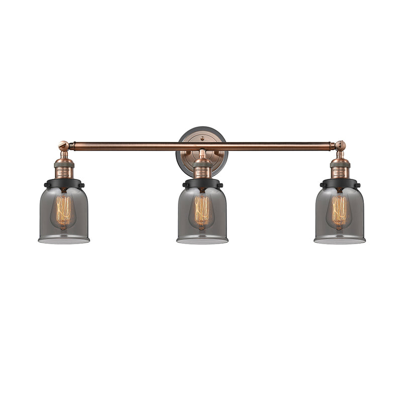 Bell Bath Vanity Light shown in the Antique Copper finish with a Plated Smoke shade