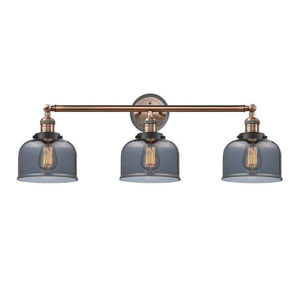 Bell Bath Vanity Light shown in the Antique Copper finish with a Plated Smoke shade