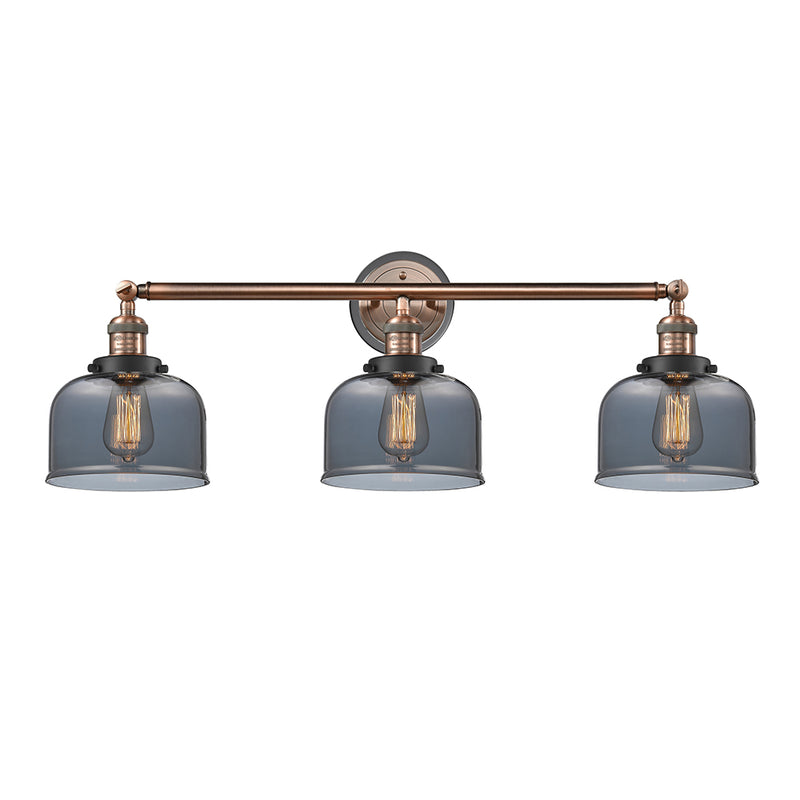 Bell Bath Vanity Light shown in the Antique Copper finish with a Plated Smoke shade