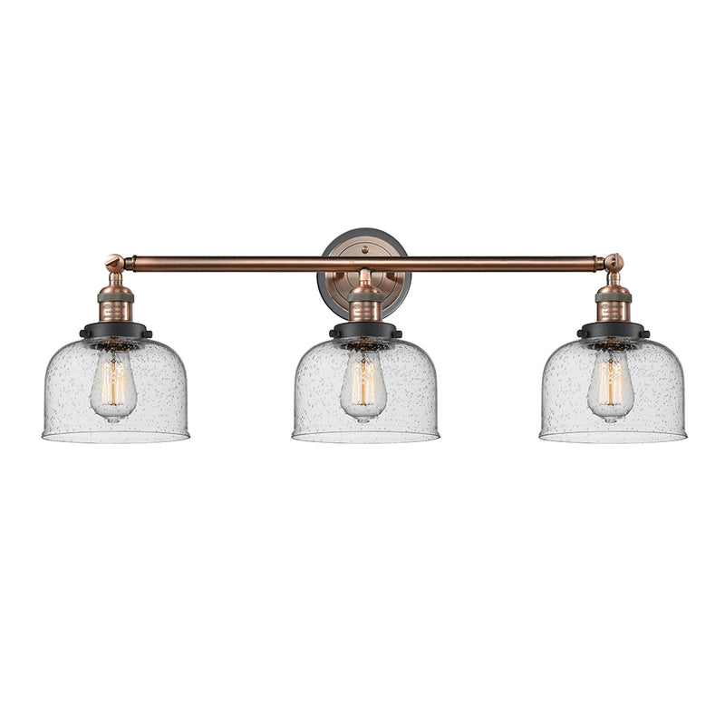Bell Bath Vanity Light shown in the Antique Copper finish with a Seedy shade
