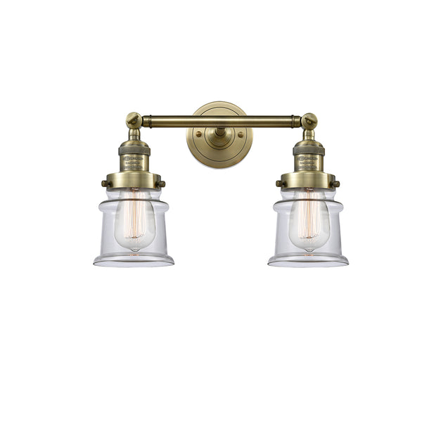 Canton Bath Vanity Light shown in the Antique Brass finish with a Clear shade