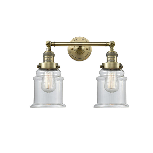 Canton Bath Vanity Light shown in the Antique Brass finish with a Clear shade