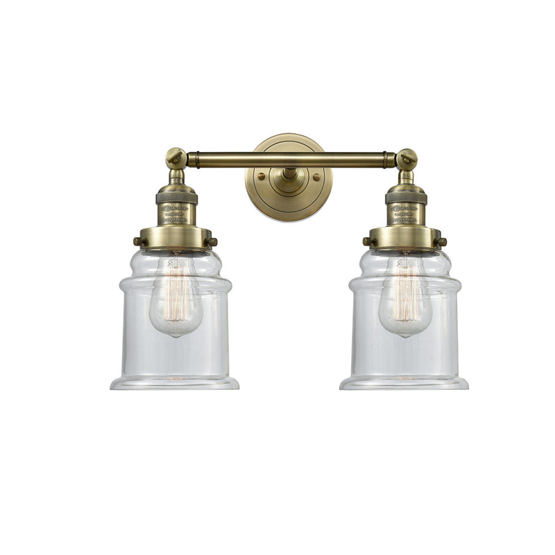 Canton Bath Vanity Light shown in the Antique Brass finish with a Clear shade