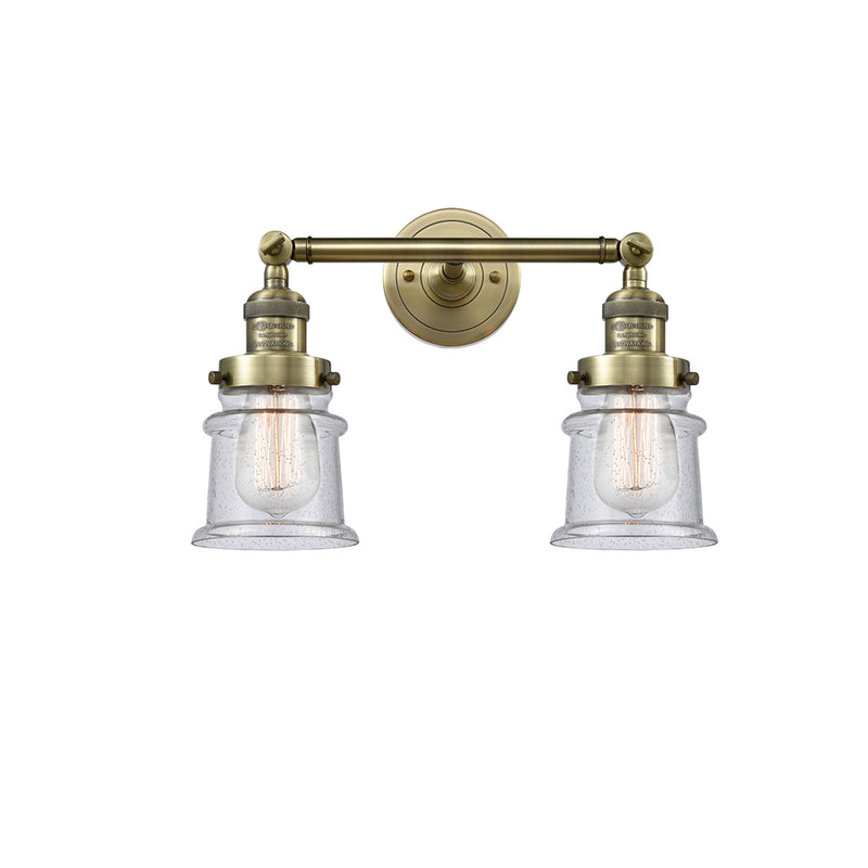 Canton Bath Vanity Light shown in the Antique Brass finish with a Seedy shade