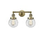 Beacon Bath Vanity Light shown in the Antique Brass finish with a Clear shade