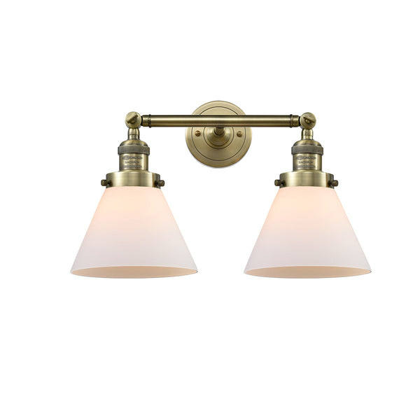 Cone Bath Vanity Light shown in the Antique Brass finish with a Matte White shade