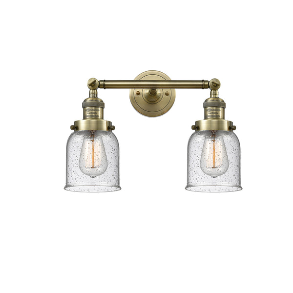 Bell Bath Vanity Light shown in the Antique Brass finish with a Seedy shade