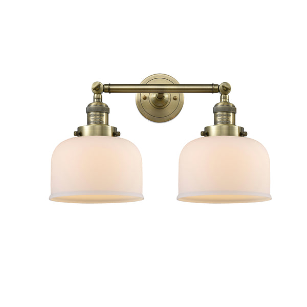 Bell Bath Vanity Light shown in the Antique Brass finish with a Matte White shade