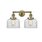 Bell Bath Vanity Light shown in the Antique Brass finish with a Clear shade