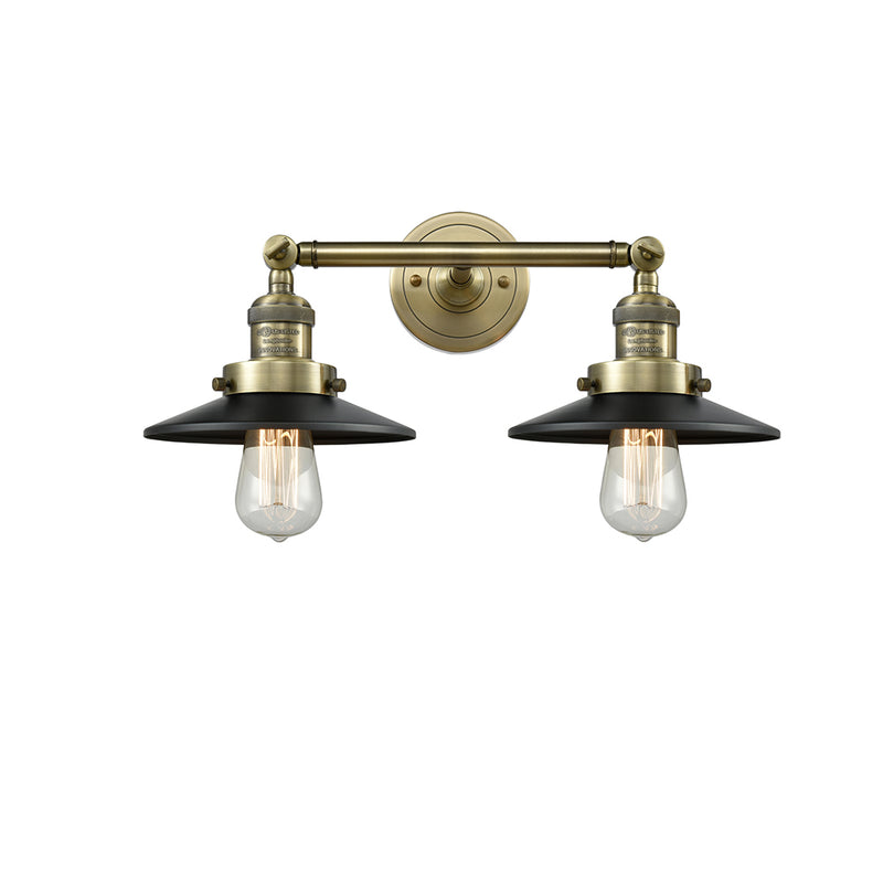 Railroad Bath Vanity Light shown in the Antique Brass finish with a Matte Black shade