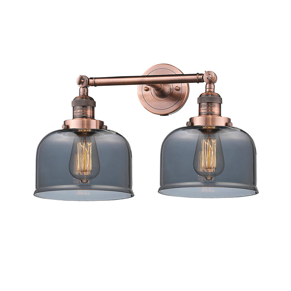 Bell Bath Vanity Light shown in the Antique Copper finish with a Plated Smoke shade