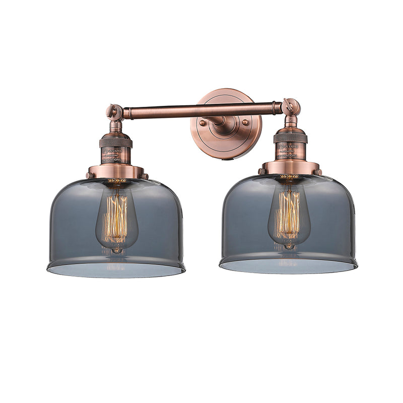 Bell Bath Vanity Light shown in the Antique Copper finish with a Plated Smoke shade