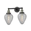 Geneseo Bath Vanity Light shown in the Black Antique Brass finish with a Clear Crackled shade