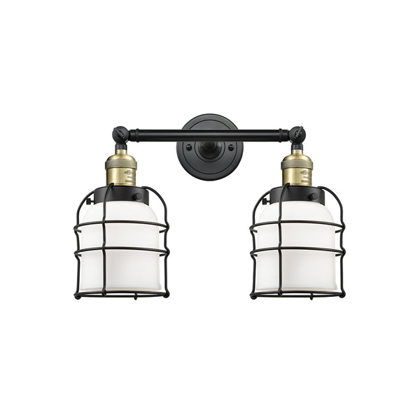 Bell Cage Bath Vanity Light shown in the Black Antique Brass finish with a Matte White shade