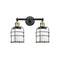 Bell Cage Bath Vanity Light shown in the Black Antique Brass finish with a Matte White shade