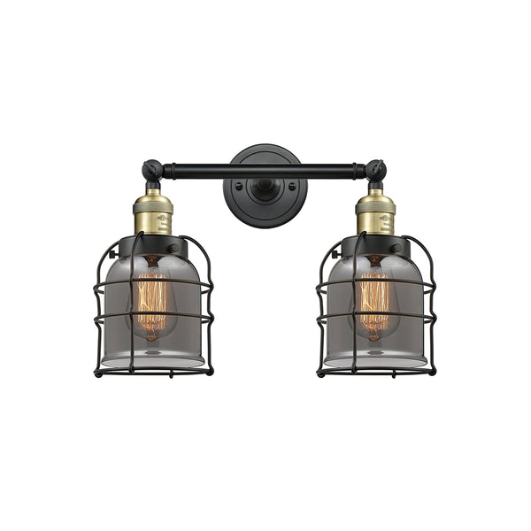 Bell Cage Bath Vanity Light shown in the Black Antique Brass finish with a Plated Smoke shade