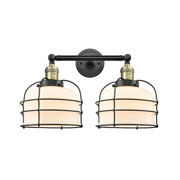Bell Cage Bath Vanity Light shown in the Black Antique Brass finish with a Matte White shade