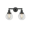 Beacon Bath Vanity Light shown in the Matte Black finish with a Clear shade
