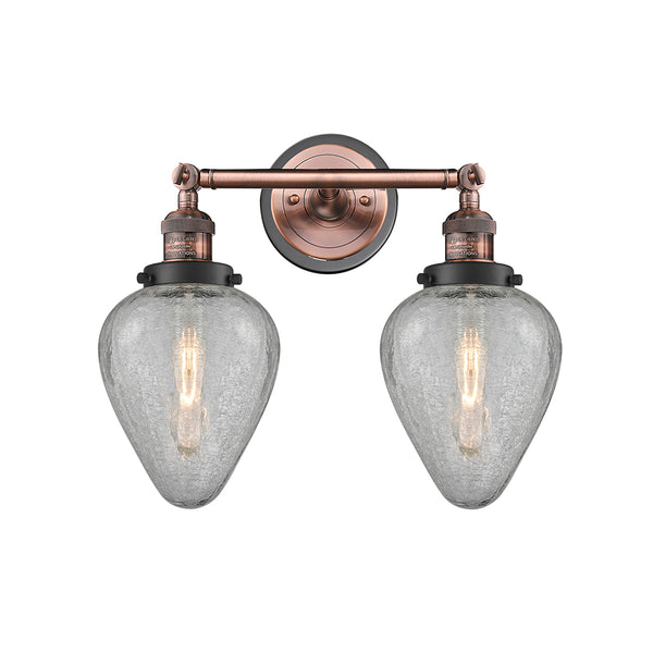 Geneseo Bath Vanity Light shown in the Antique Copper finish with a Clear Crackled shade