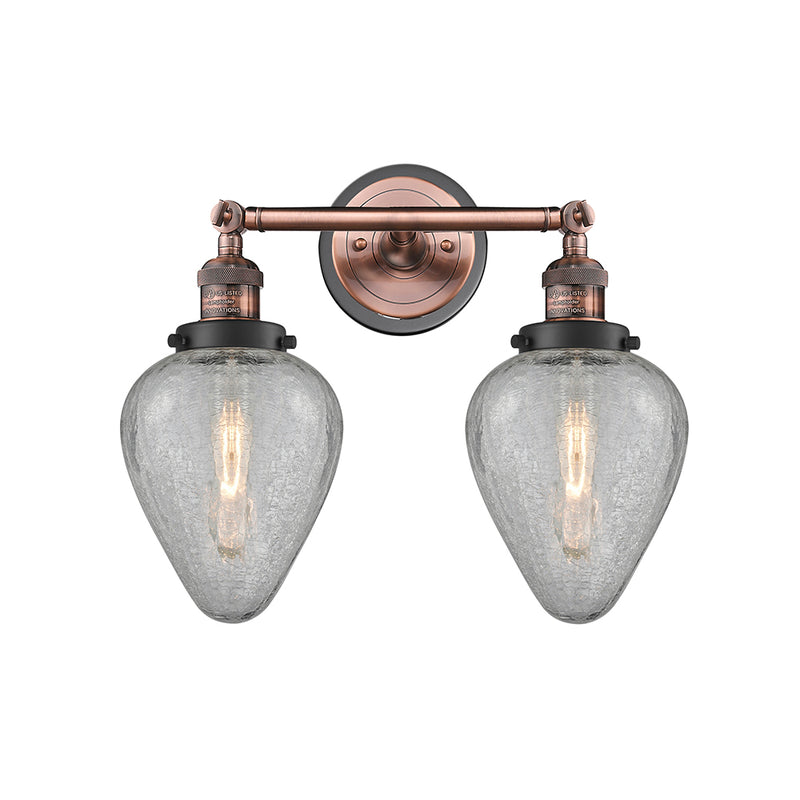 Geneseo Bath Vanity Light shown in the Antique Copper finish with a Clear Crackled shade