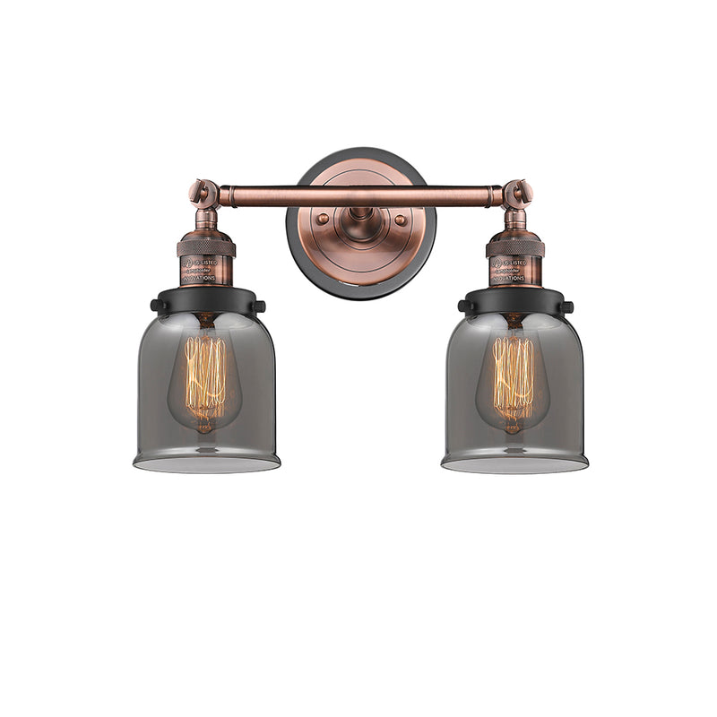 Bell Bath Vanity Light shown in the Antique Copper finish with a Plated Smoke shade