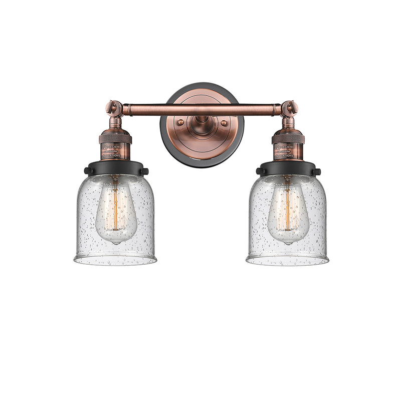 Bell Bath Vanity Light shown in the Antique Copper finish with a Seedy shade