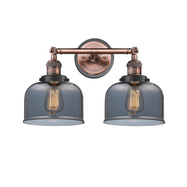Bell Bath Vanity Light shown in the Antique Copper finish with a Plated Smoke shade