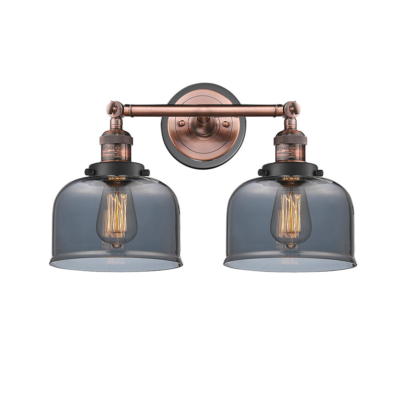 Bell Bath Vanity Light shown in the Antique Copper finish with a Plated Smoke shade