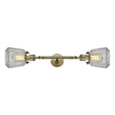 Chatham Bath Vanity Light shown in the Antique Brass finish with a Clear shade