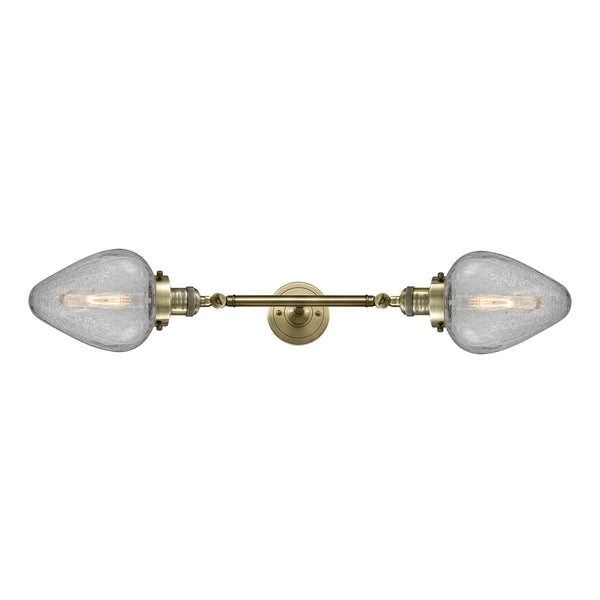 Geneseo Bath Vanity Light shown in the Antique Brass finish with a Clear Crackled shade
