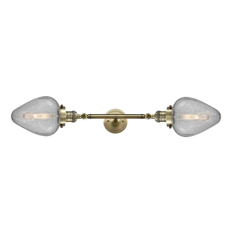 Geneseo Bath Vanity Light shown in the Antique Brass finish with a Clear Crackled shade