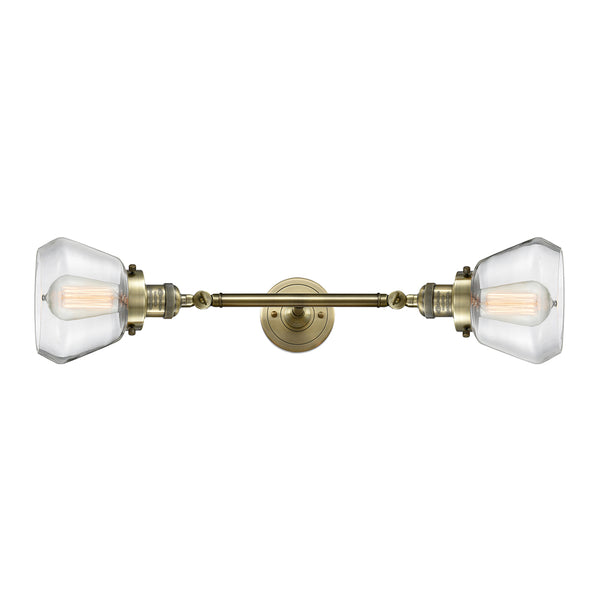 Fulton Bath Vanity Light shown in the Antique Brass finish with a Clear shade