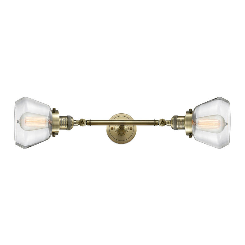Fulton Bath Vanity Light shown in the Antique Brass finish with a Clear shade
