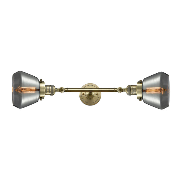 Fulton Bath Vanity Light shown in the Antique Brass finish with a Plated Smoke shade