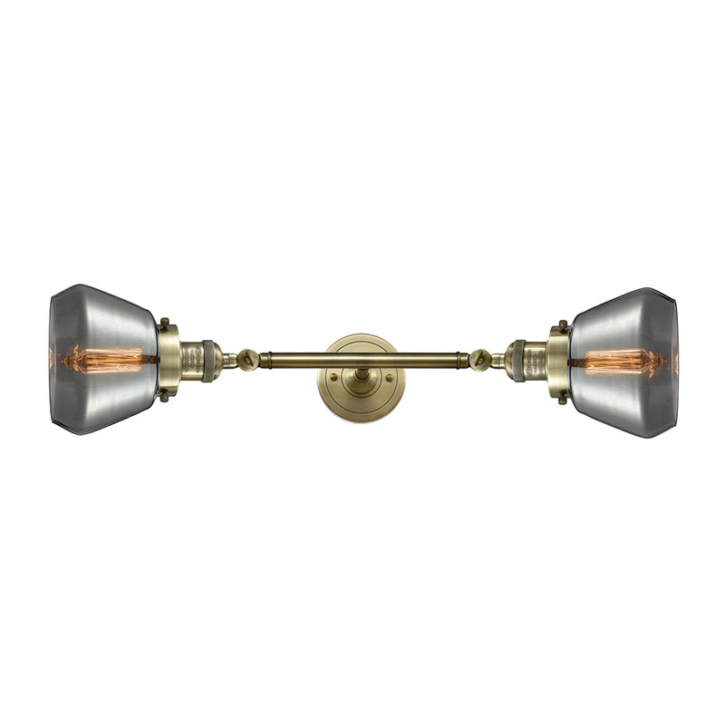 Fulton Bath Vanity Light shown in the Antique Brass finish with a Plated Smoke shade