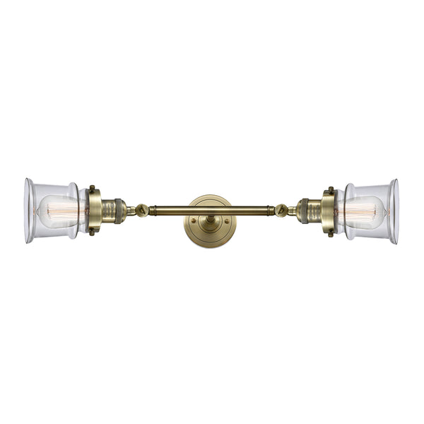 Canton Bath Vanity Light shown in the Antique Brass finish with a Clear shade