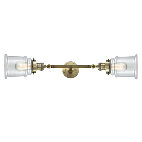 Canton Bath Vanity Light shown in the Antique Brass finish with a Clear shade