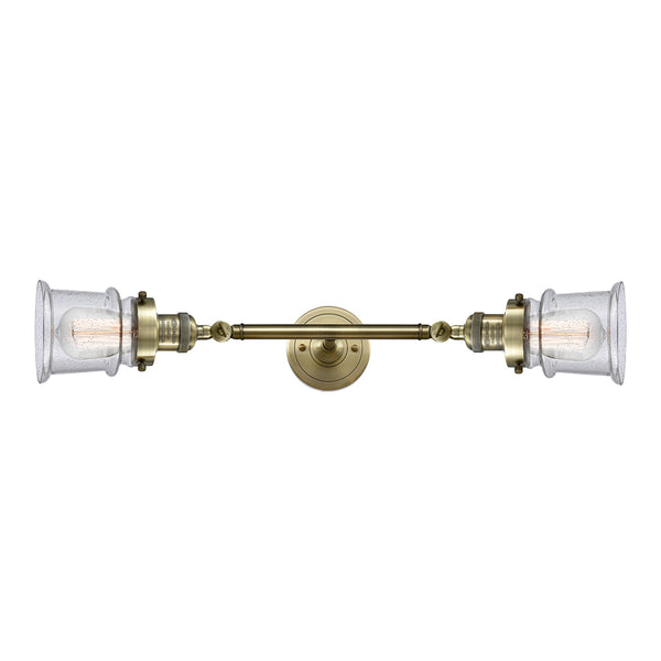 Canton Bath Vanity Light shown in the Antique Brass finish with a Seedy shade