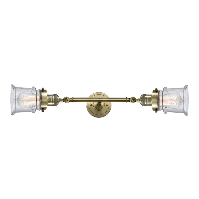 Canton Bath Vanity Light shown in the Antique Brass finish with a Seedy shade