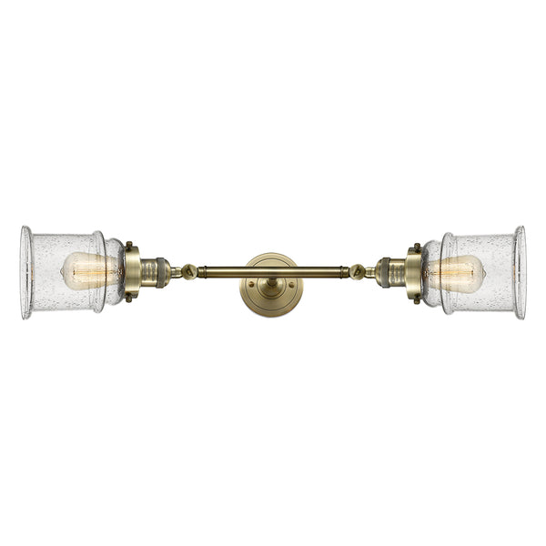 Canton Bath Vanity Light shown in the Antique Brass finish with a Seedy shade