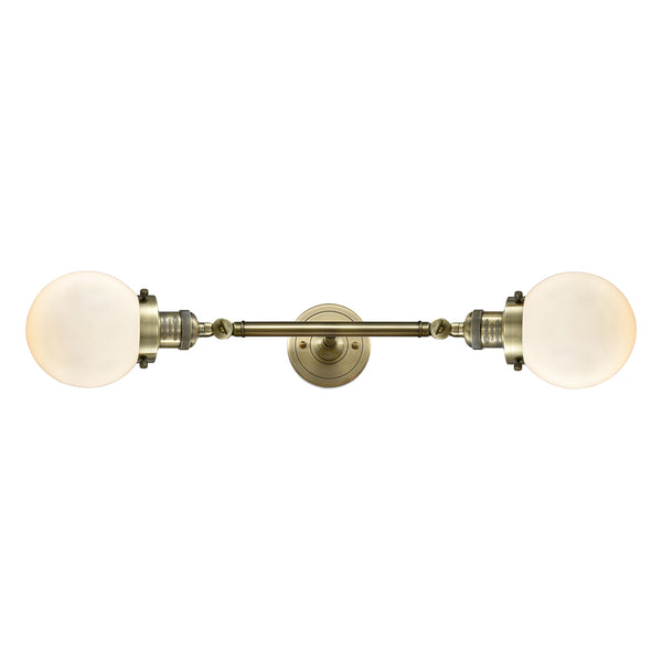 Beacon Bath Vanity Light shown in the Antique Brass finish with a Matte White shade