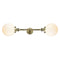 Beacon Bath Vanity Light shown in the Antique Brass finish with a Matte White shade