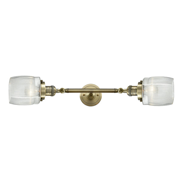 Colton Bath Vanity Light shown in the Antique Brass finish with a Clear Halophane shade