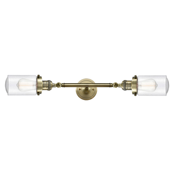 Dover Bath Vanity Light shown in the Antique Brass finish with a Seedy shade