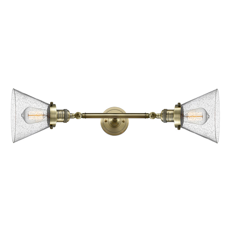 Cone Bath Vanity Light shown in the Antique Brass finish with a Seedy shade